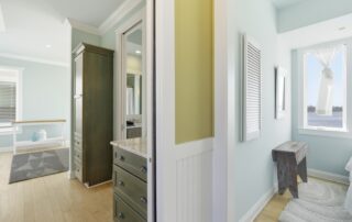 Bright, airy interior with light blue walls, hardwood floors, and a view of the water; ideal for Southport rentals.